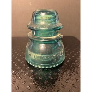 vintage Hemingray-42 glass insulator in a teal-aqua blue color